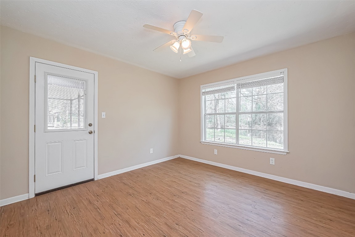 14 Veronica Lane Huntsville, TX 77340 - Photo 22 of 50 a view of an empty room with wooden floor and a window
