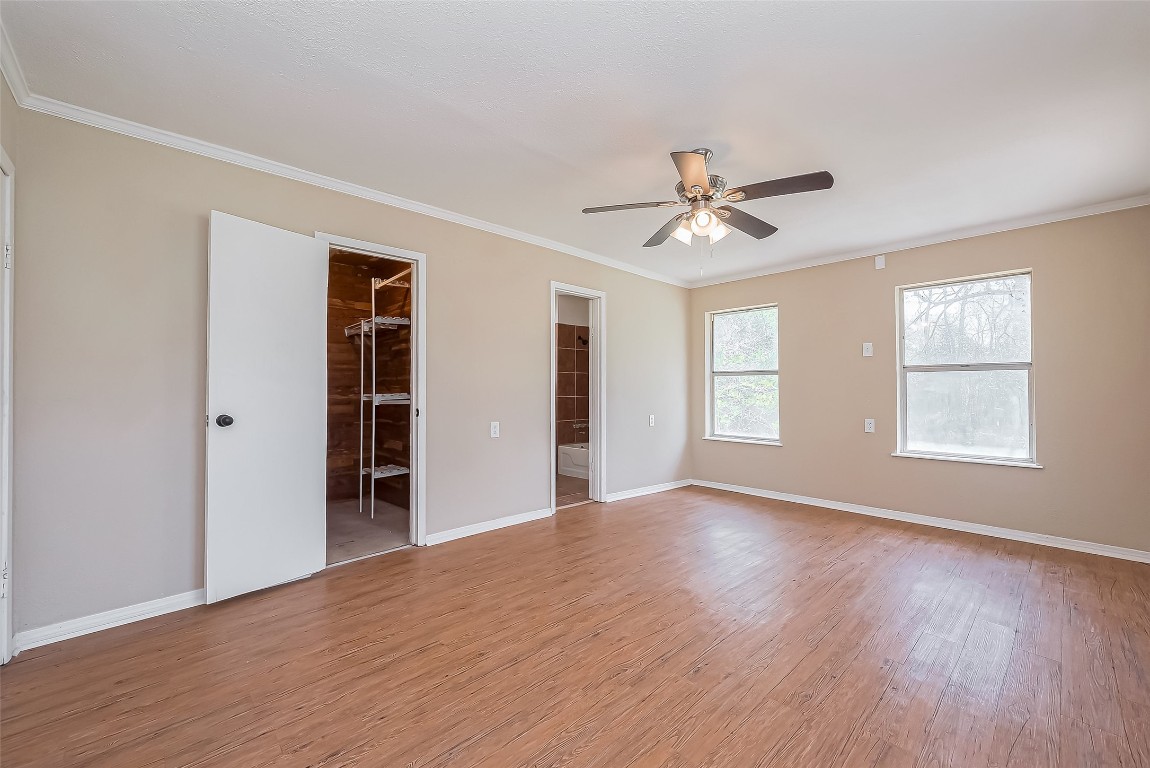 14 Veronica Lane Huntsville, TX 77340 - Photo 26 of 50 an empty room with wooden floor and windows