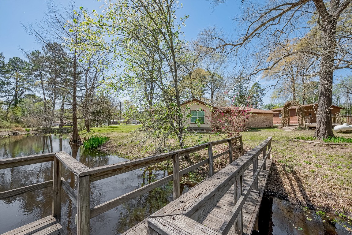 14 Veronica Lane Huntsville, TX 77340 - Photo 42 of 50 a view of a balcony with wooden floor and fence