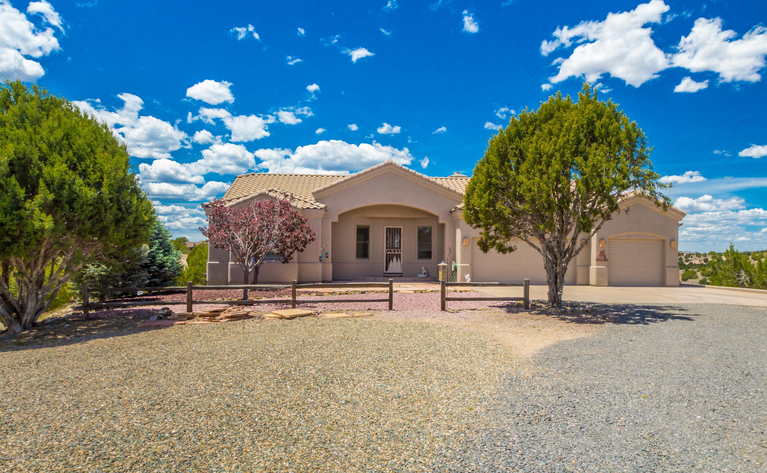 a front view of a house with a yard and a garage