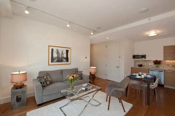 a living room with furniture and kitchen view