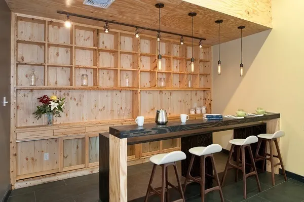 a table with chairs and white cabinets