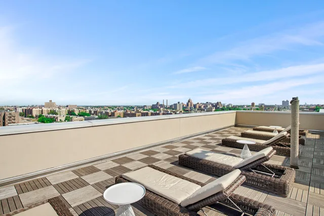 a view of a terrace with furniture and city view