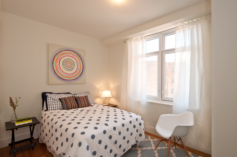 301 Sullivan Place, Unit 4Q Brooklyn, NY 11225 - Photo 4 of 27 a bedroom with a bed and a lamp