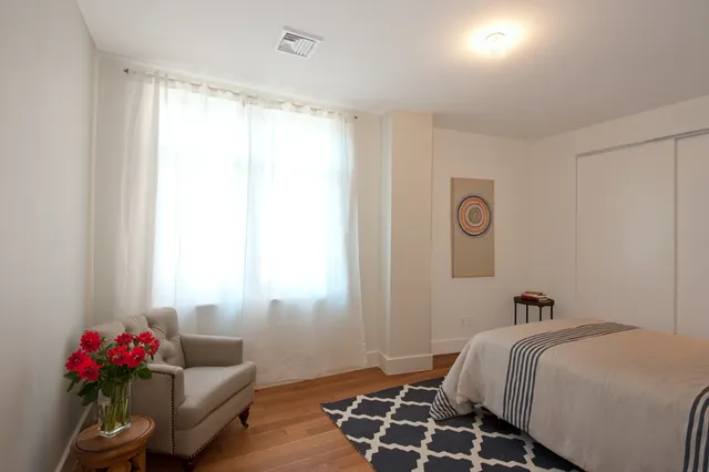 a bedroom with a bed and a window