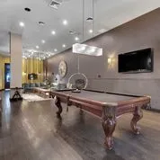 a room with a table chairs and flat screen tv