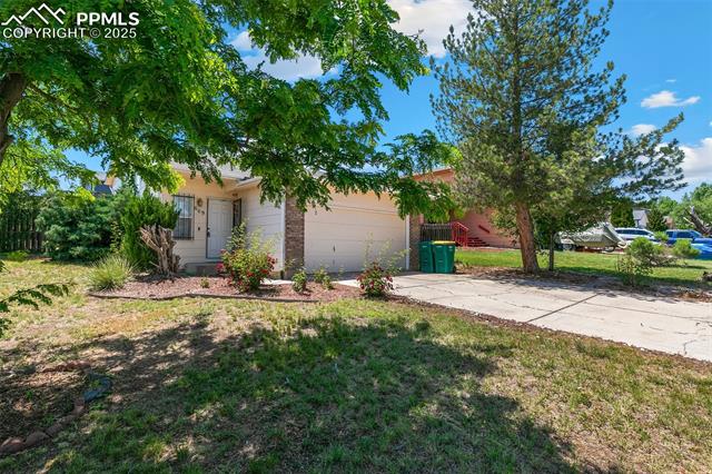 609 Wheat Field Road Fountain, CO 80817 - Photo 2 of 29 View of front of house with a garage, concrete driveway, and a front yard