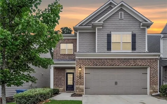 a front view of a house with garage