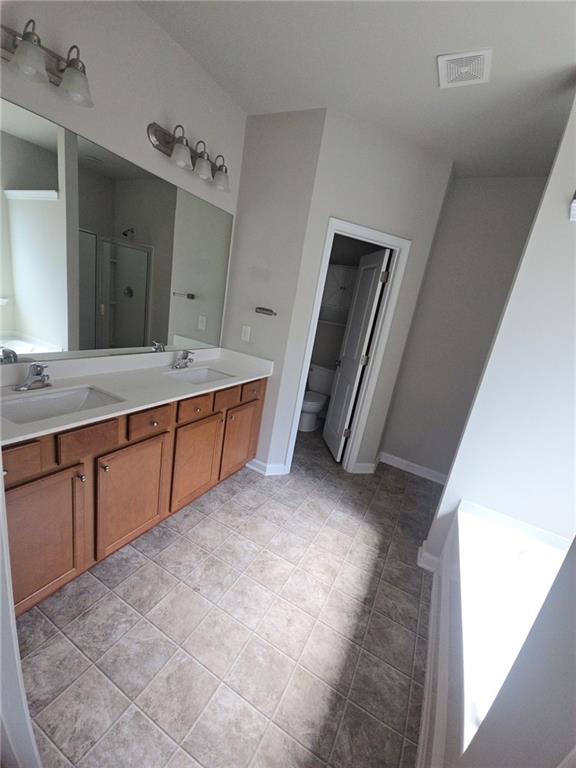 1929 Charcoal Ives Road Lawrenceville, GA 30045 - Photo 12 of 14 a spacious bathroom with a granite countertop sink and mirror