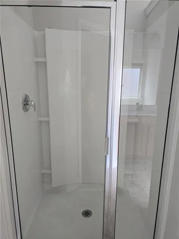 a bathroom with a glass shower door