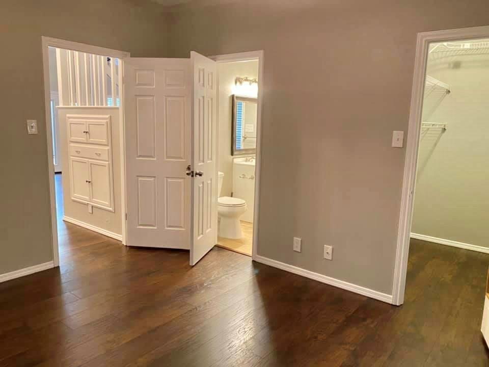 4404 Travis Country Circle, Unit G4 Austin, TX 78735 - Photo 6 of 15 Rich hardwood flooring guides you through this home's well-appointed interior spaces.