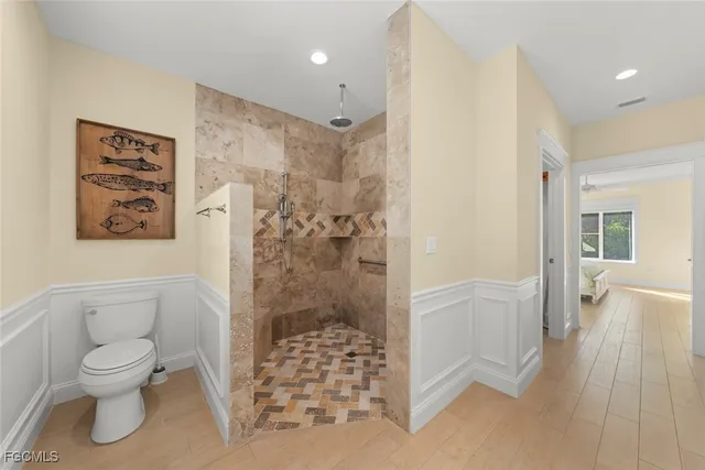 a bathroom with a toilet and a shower