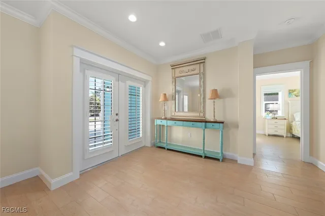 an empty room with windows and cabinet
