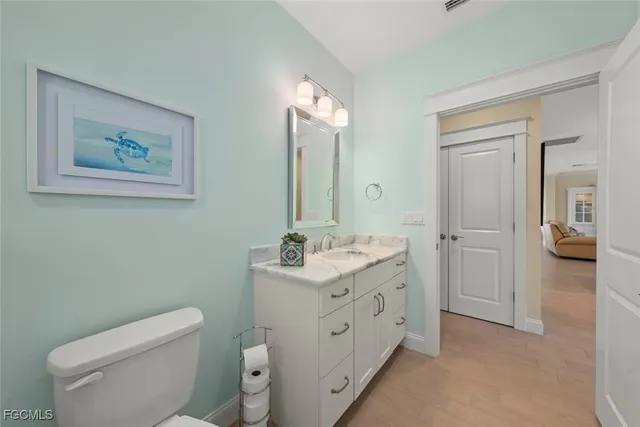 a spacious bathroom with a toilet sink and mirror
