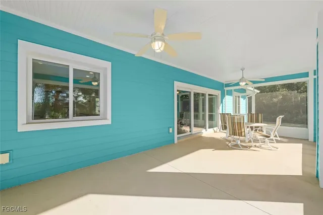 a room with a window and ceiling fan