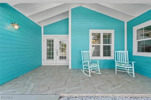 a view of backyard with deck and a chair