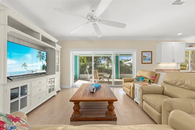 a living room with furniture a large window and a flat screen tv