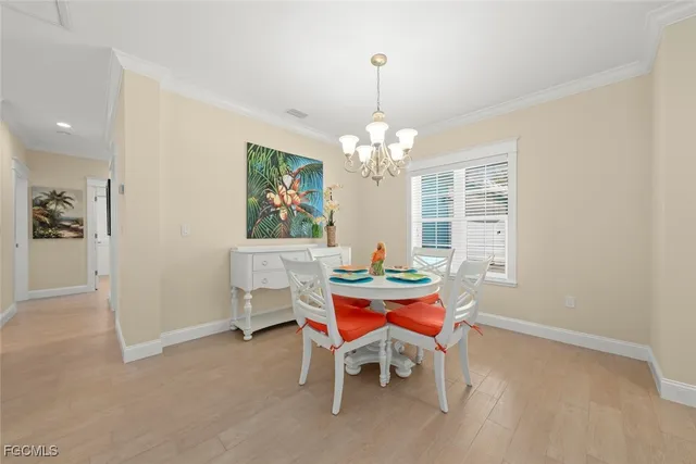 a dining room with furniture a chandelier and window