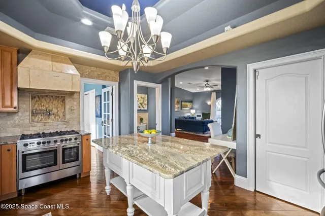 a kitchen with stainless steel appliances granite countertop a stove and a cabinets