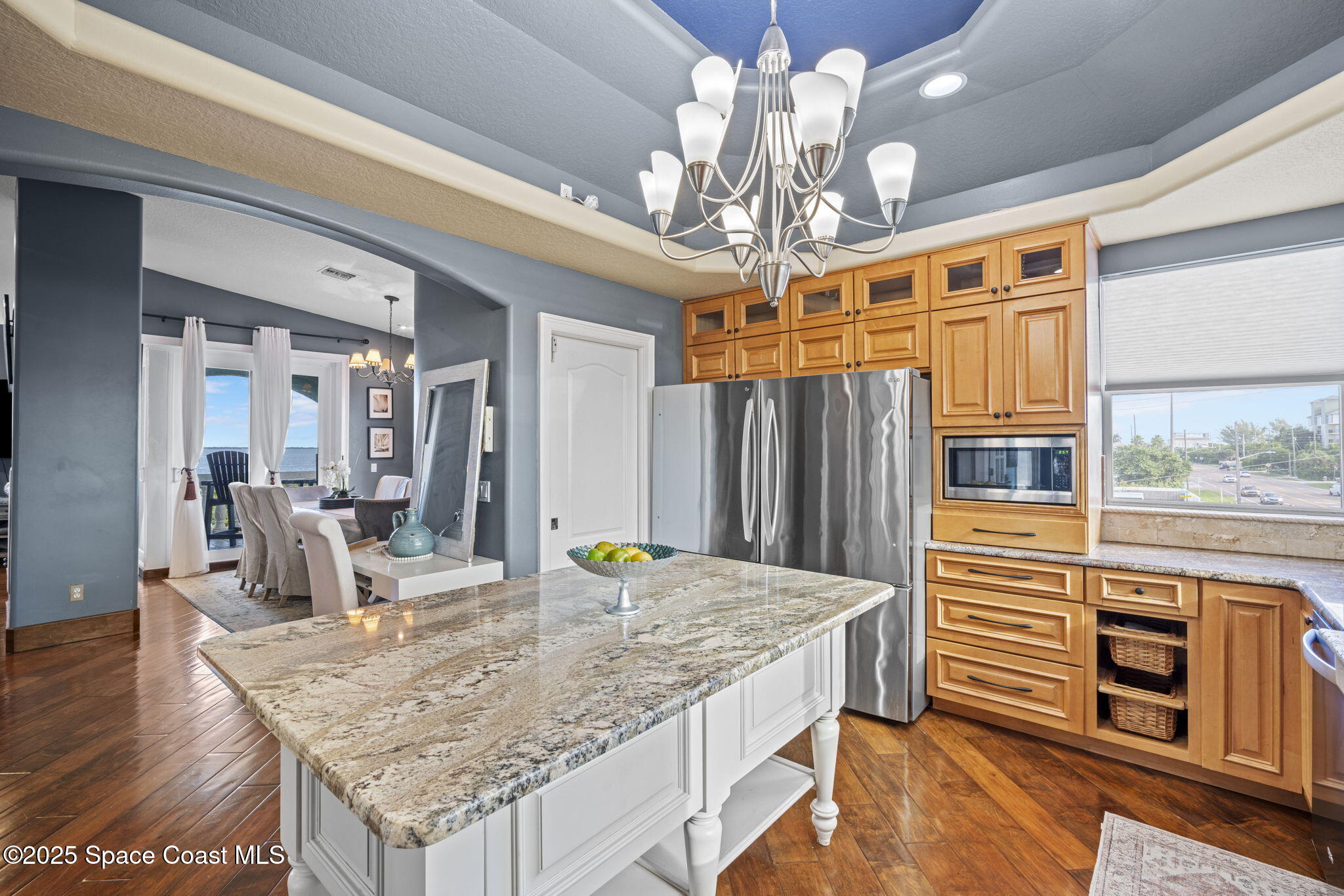 2694 South Atlantic Avenue Cocoa Beach, FL 32931 - Photo 17 of 72 a view of a dining room with furniture a chandelier and wooden floor