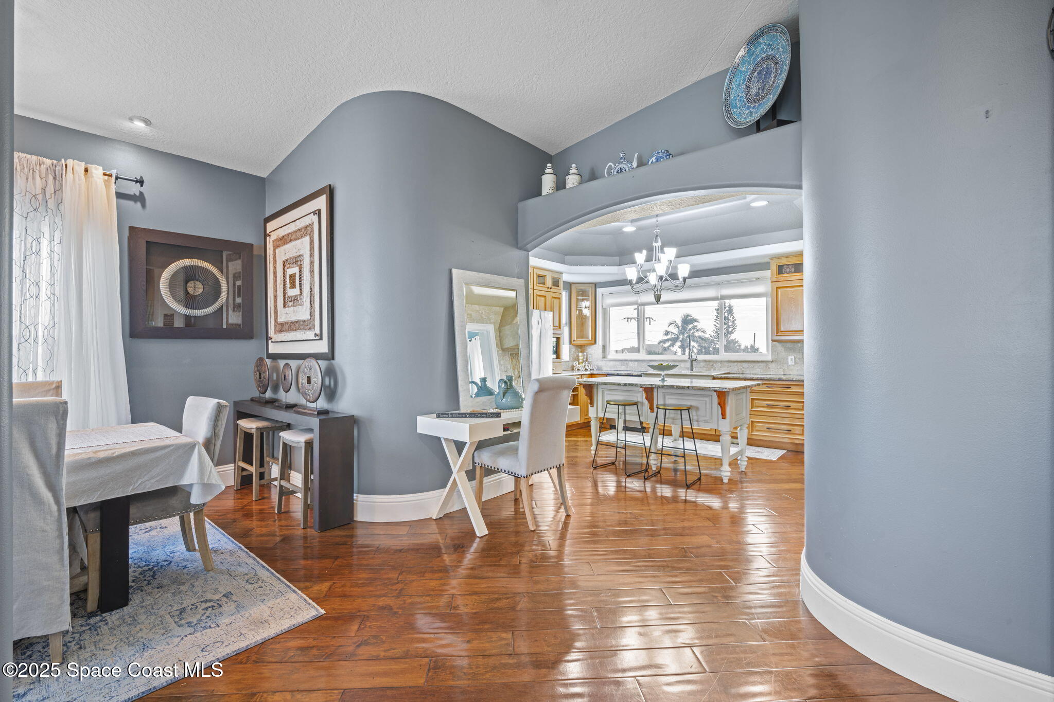 2694 South Atlantic Avenue Cocoa Beach, FL 32931 - Photo 20 of 72 a dining room with wooden floor a glass table and chairs