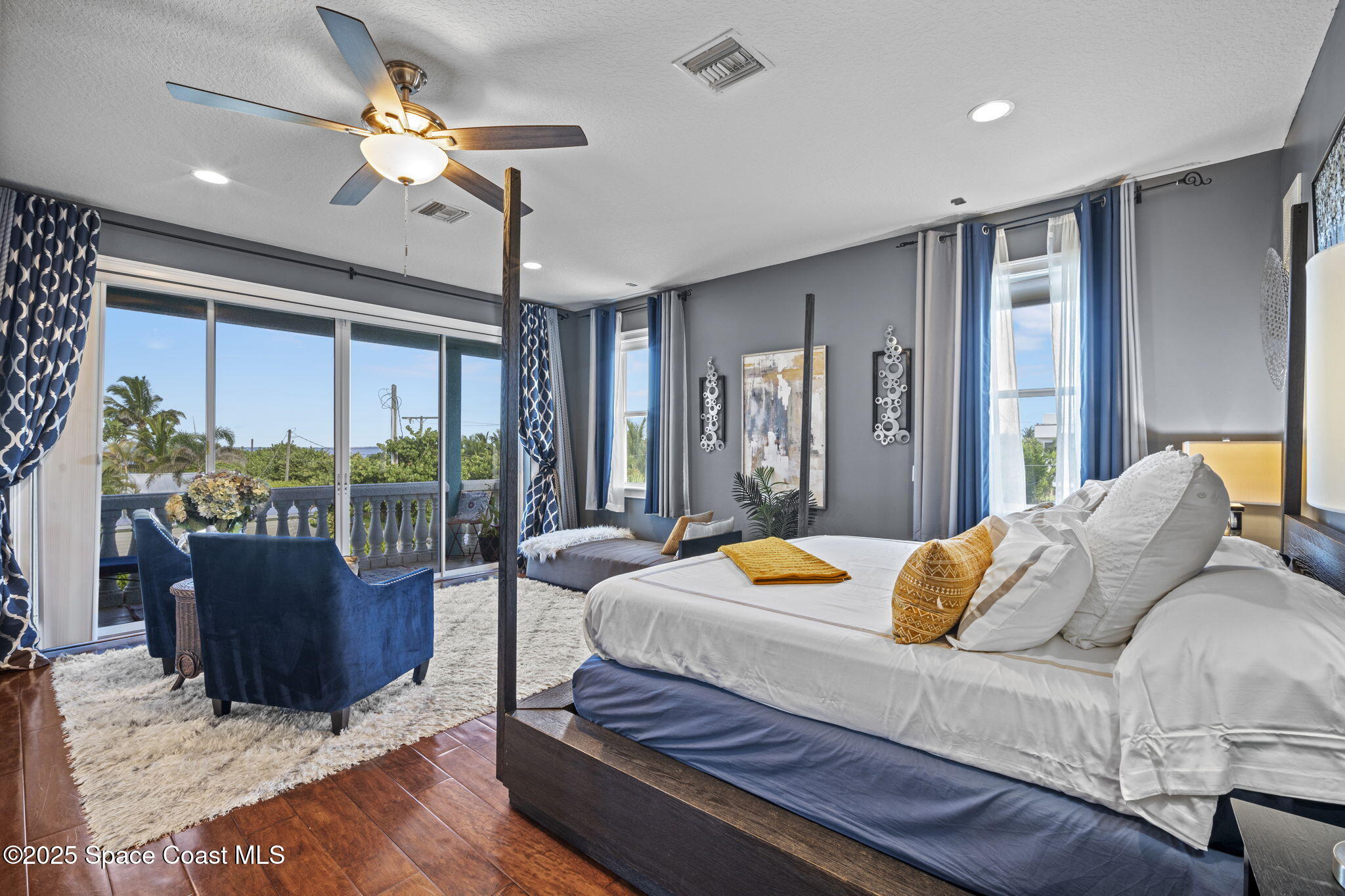 2694 South Atlantic Avenue Cocoa Beach, FL 32931 - Photo 24 of 72 a bedroom with a bed and a chandelier