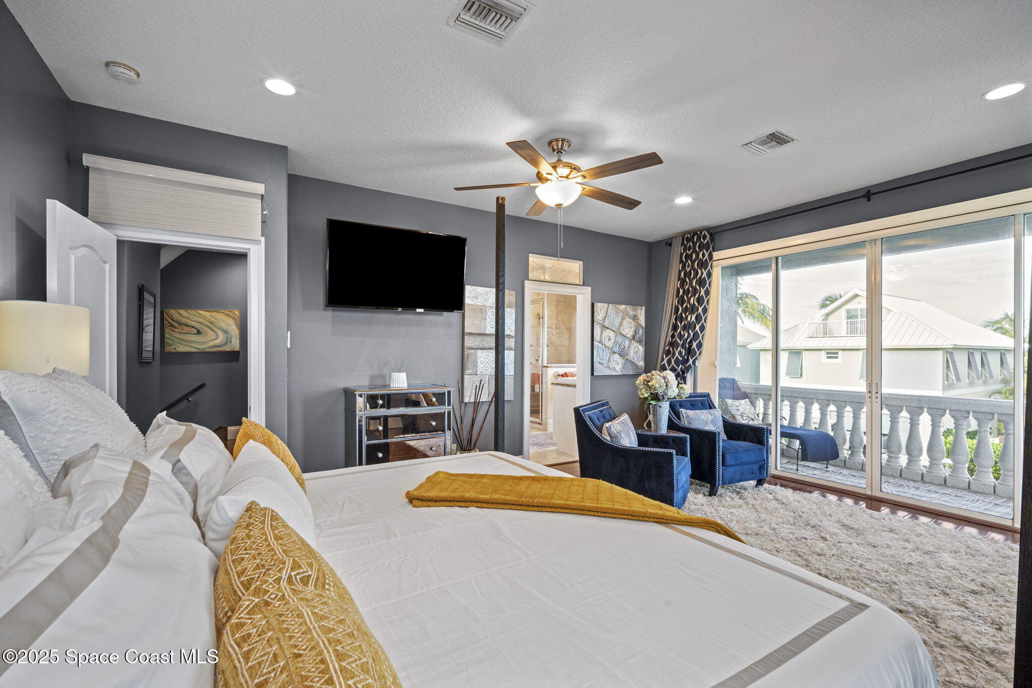 2694 South Atlantic Avenue Cocoa Beach, FL 32931 - Photo 25 of 72 a living room with furniture a flat screen tv and a fireplace