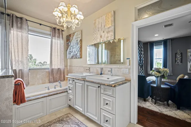 a spacious bathroom with a granite countertop toilet a sink and a bathtub