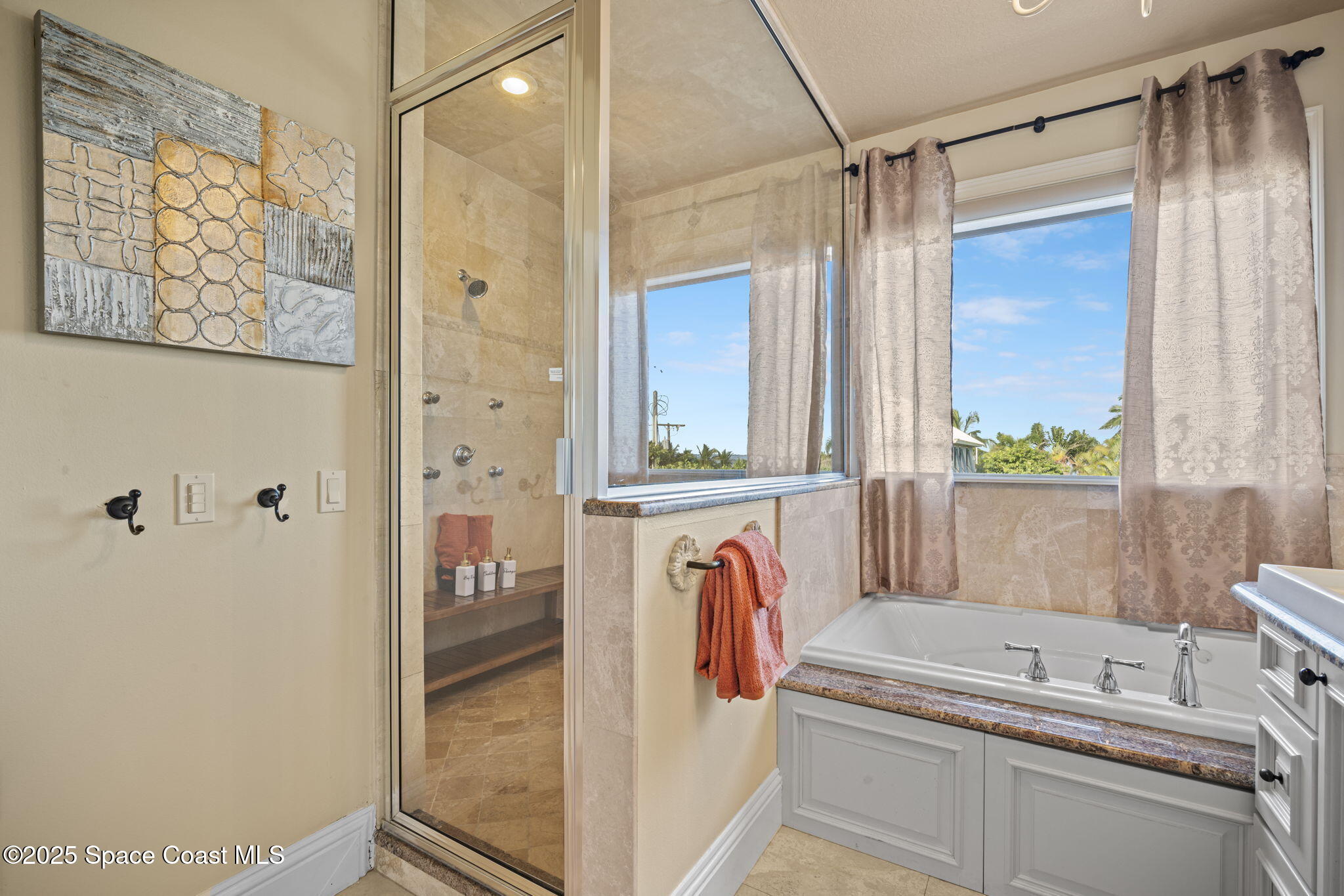 2694 South Atlantic Avenue Cocoa Beach, FL 32931 - Photo 31 of 72 a bathroom with a tub sink and mirror
