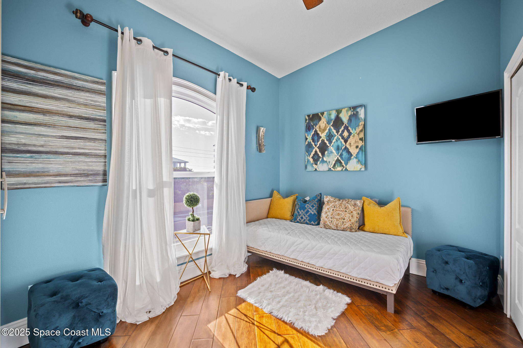 2694 South Atlantic Avenue Cocoa Beach, FL 32931 - Photo 38 of 72 a living room with furniture and a flat screen tv