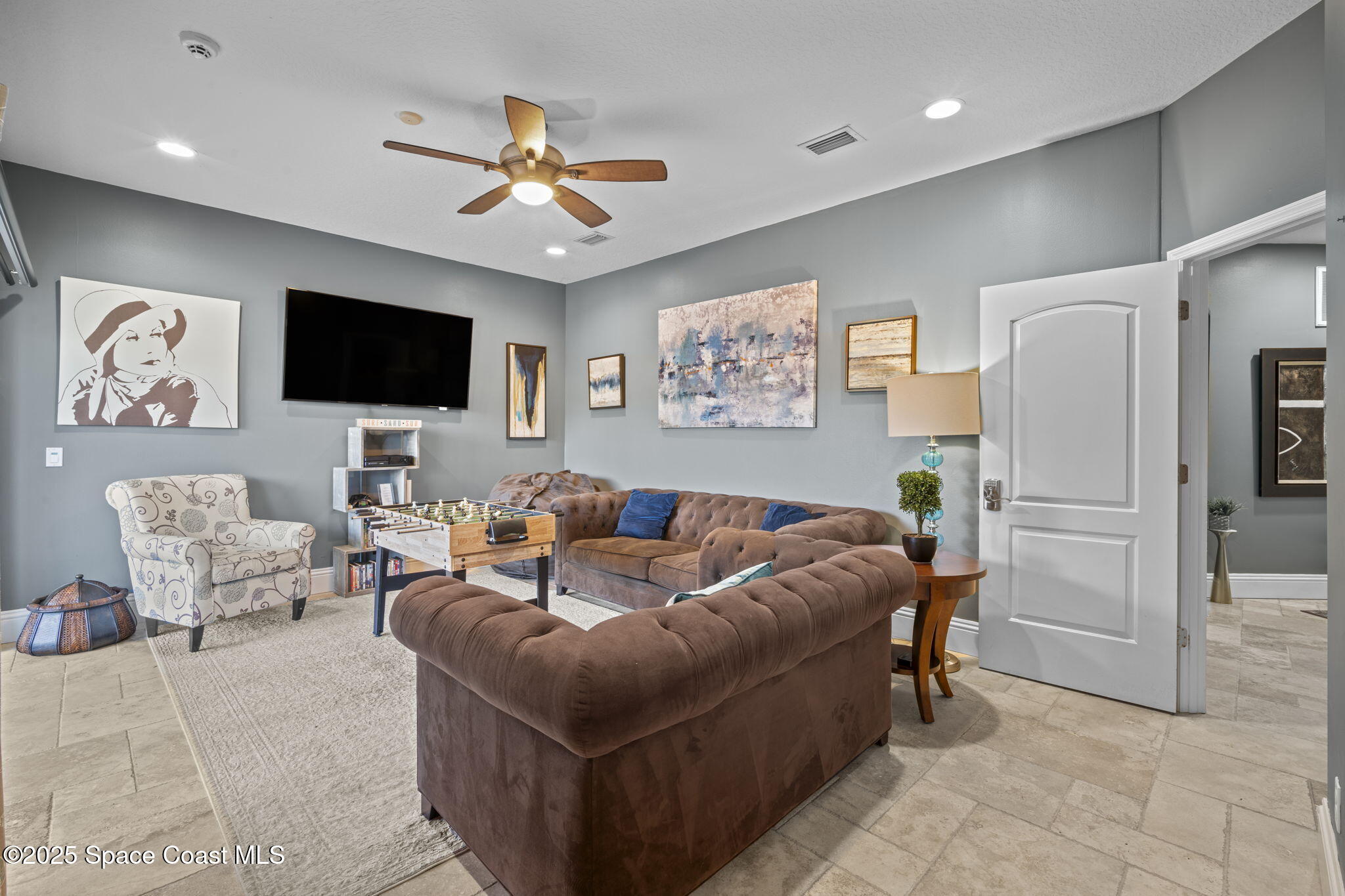 2694 South Atlantic Avenue Cocoa Beach, FL 32931 - Photo 39 of 72 a living room with furniture and a flat screen tv