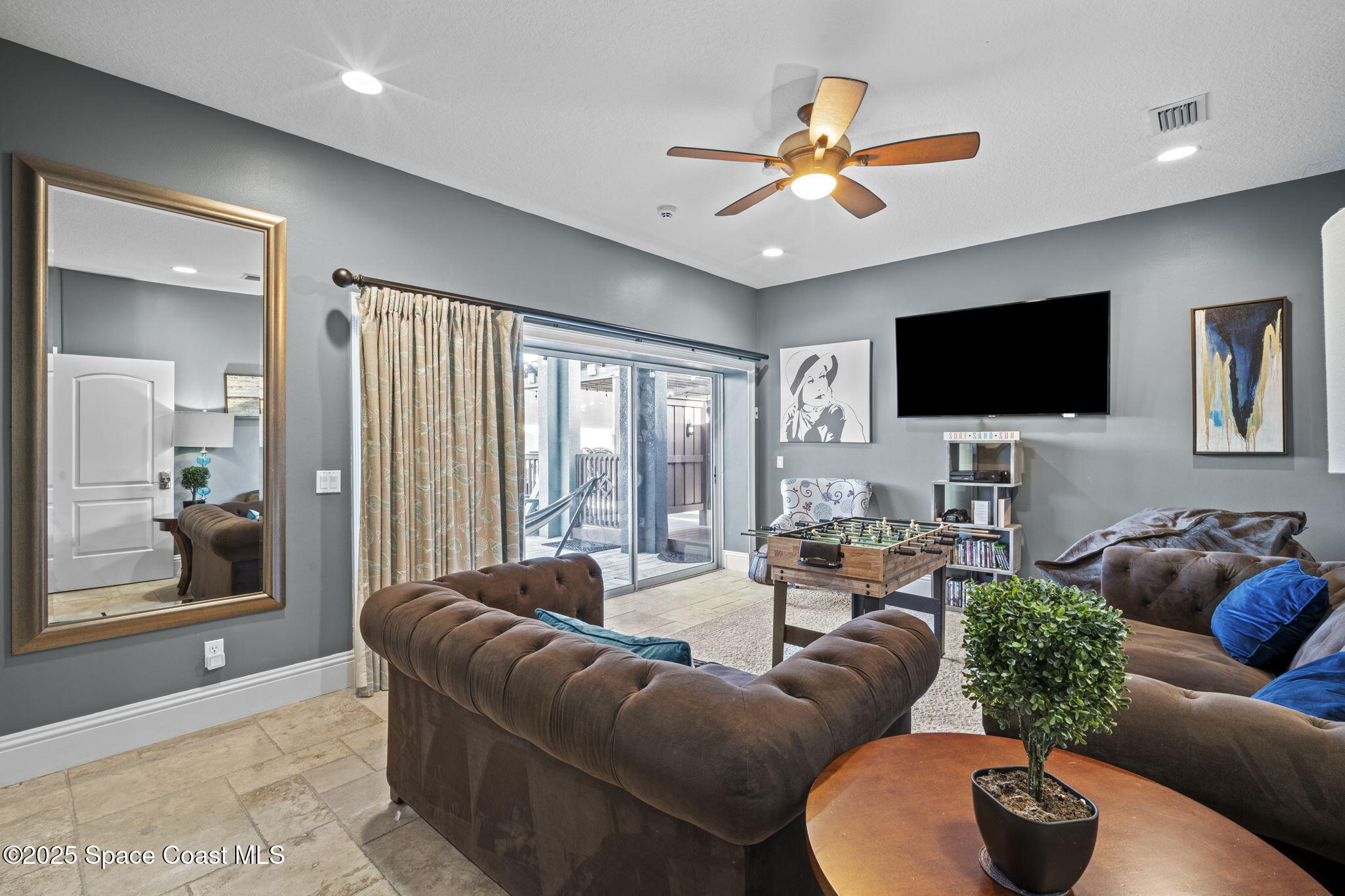 2694 South Atlantic Avenue Cocoa Beach, FL 32931 - Photo 40 of 72 a living room with furniture and a flat screen tv