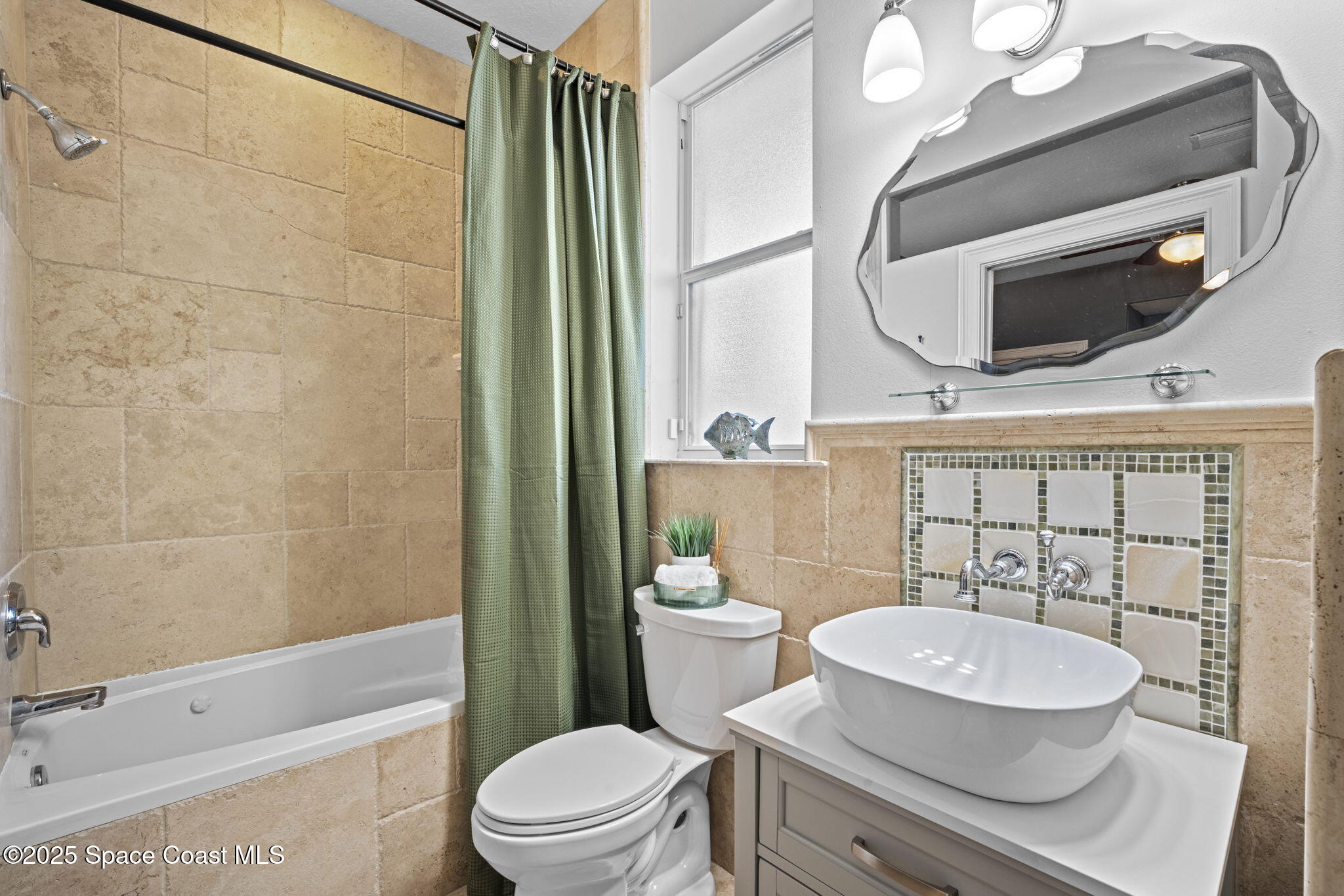 2694 South Atlantic Avenue Cocoa Beach, FL 32931 - Photo 45 of 72 a bathroom with a sink a toilet a mirror and shower