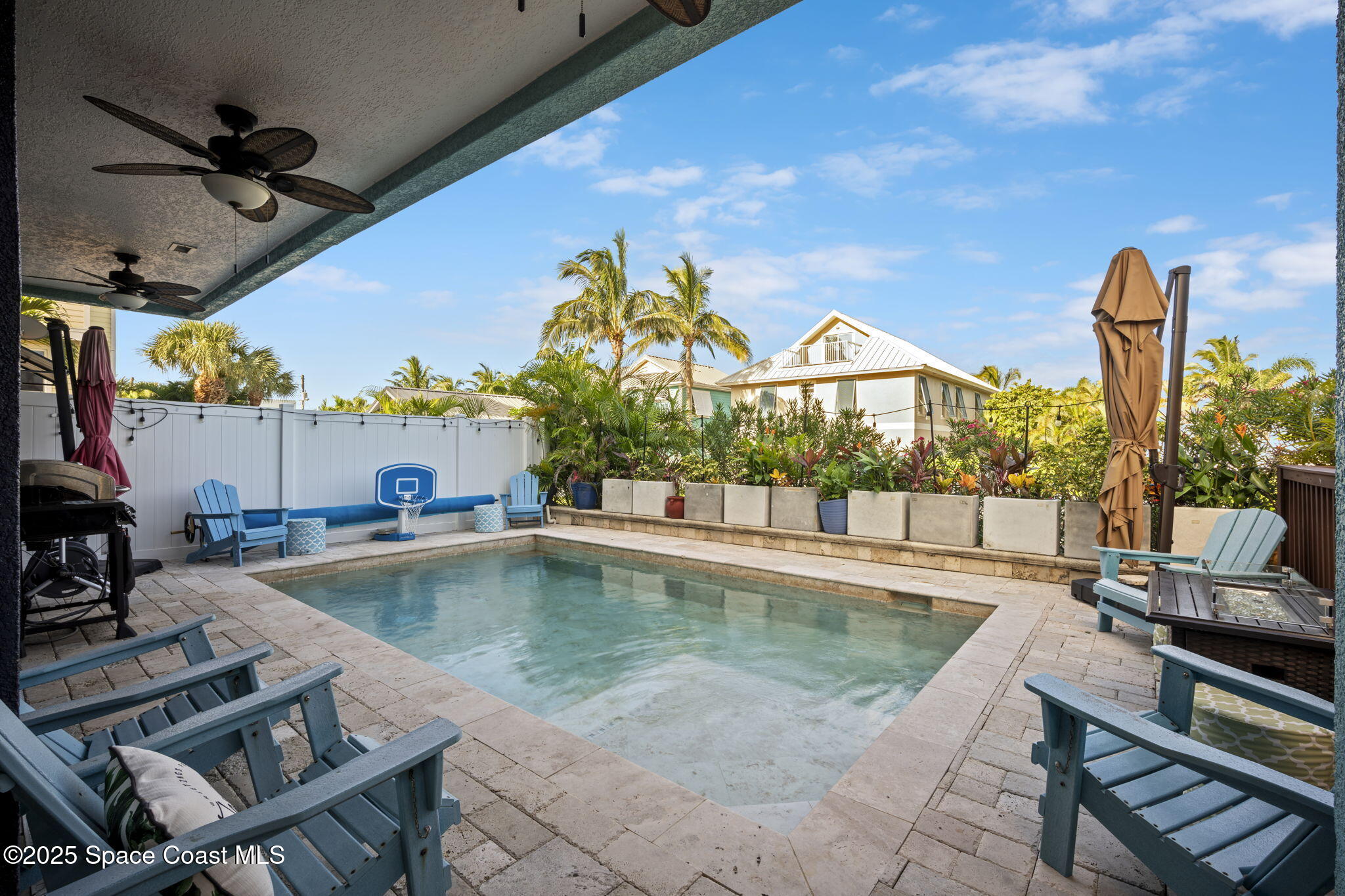 2694 South Atlantic Avenue Cocoa Beach, FL 32931 - Photo 46 of 72 a view of a swimming pool with a lounge chairs