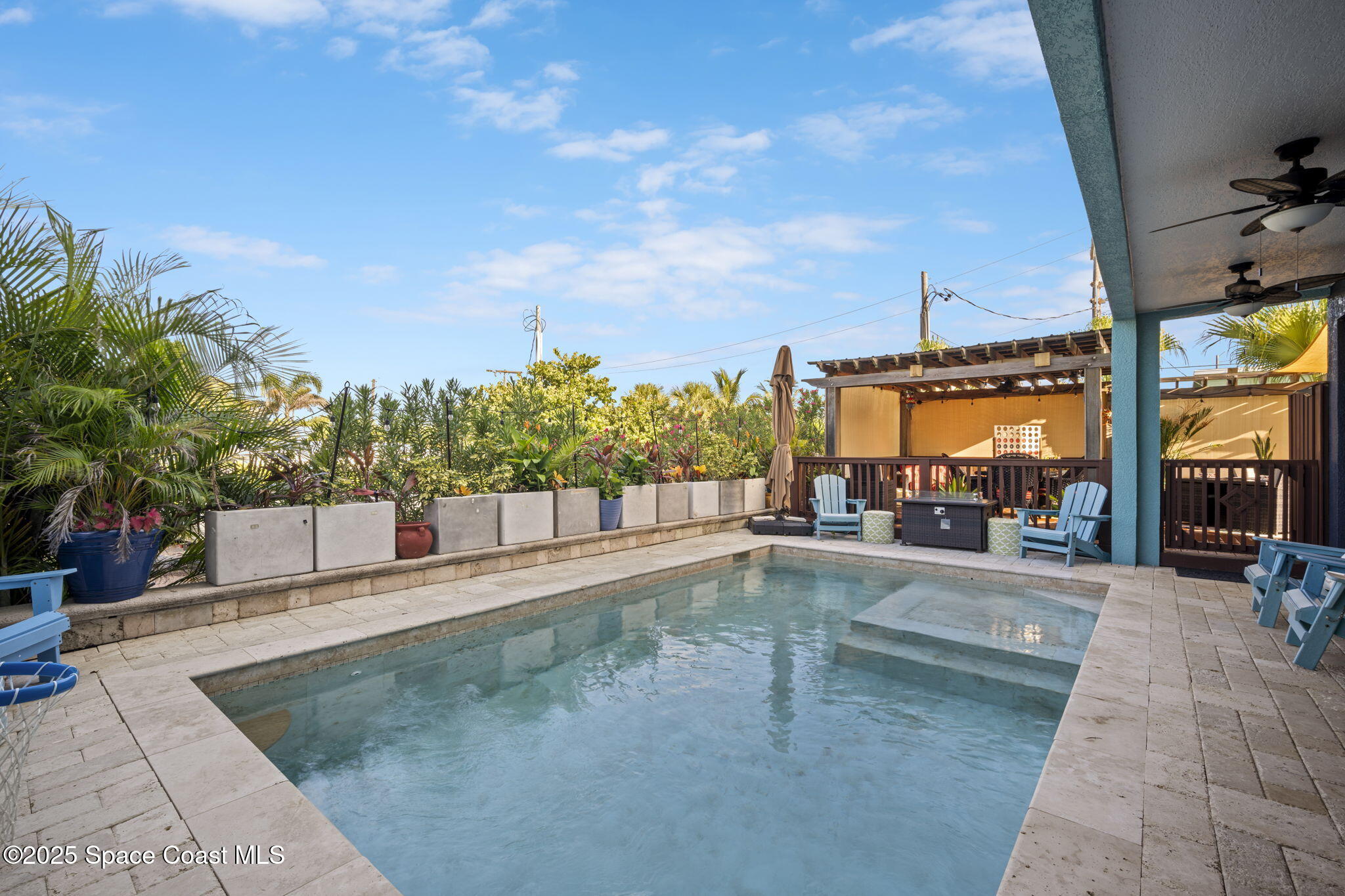 2694 South Atlantic Avenue Cocoa Beach, FL 32931 - Photo 47 of 72 a view of a swimming pool with a lounge chair