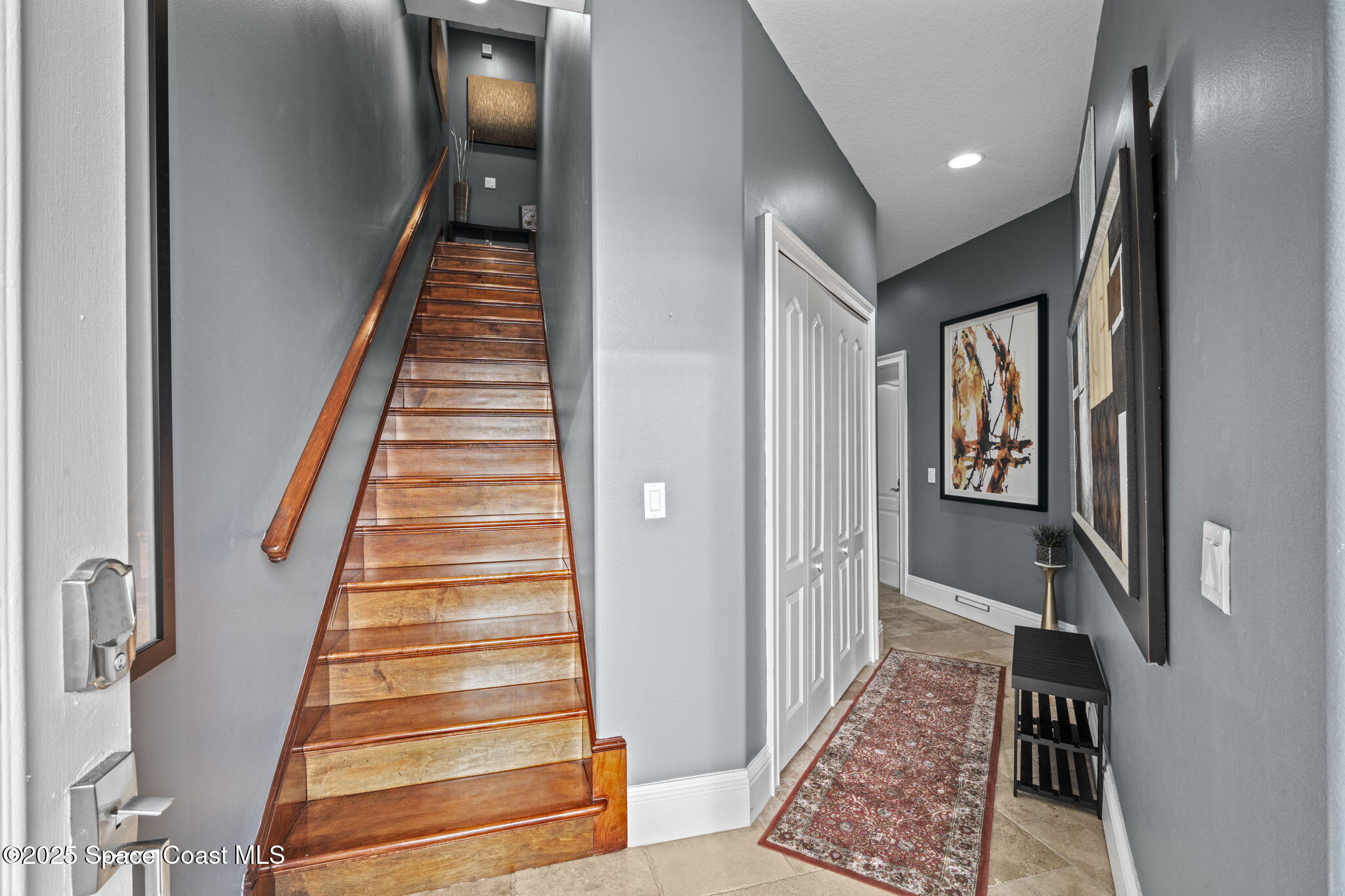 2694 South Atlantic Avenue Cocoa Beach, FL 32931 - Photo 5 of 72 a view of a hallway with wooden floor and stairs