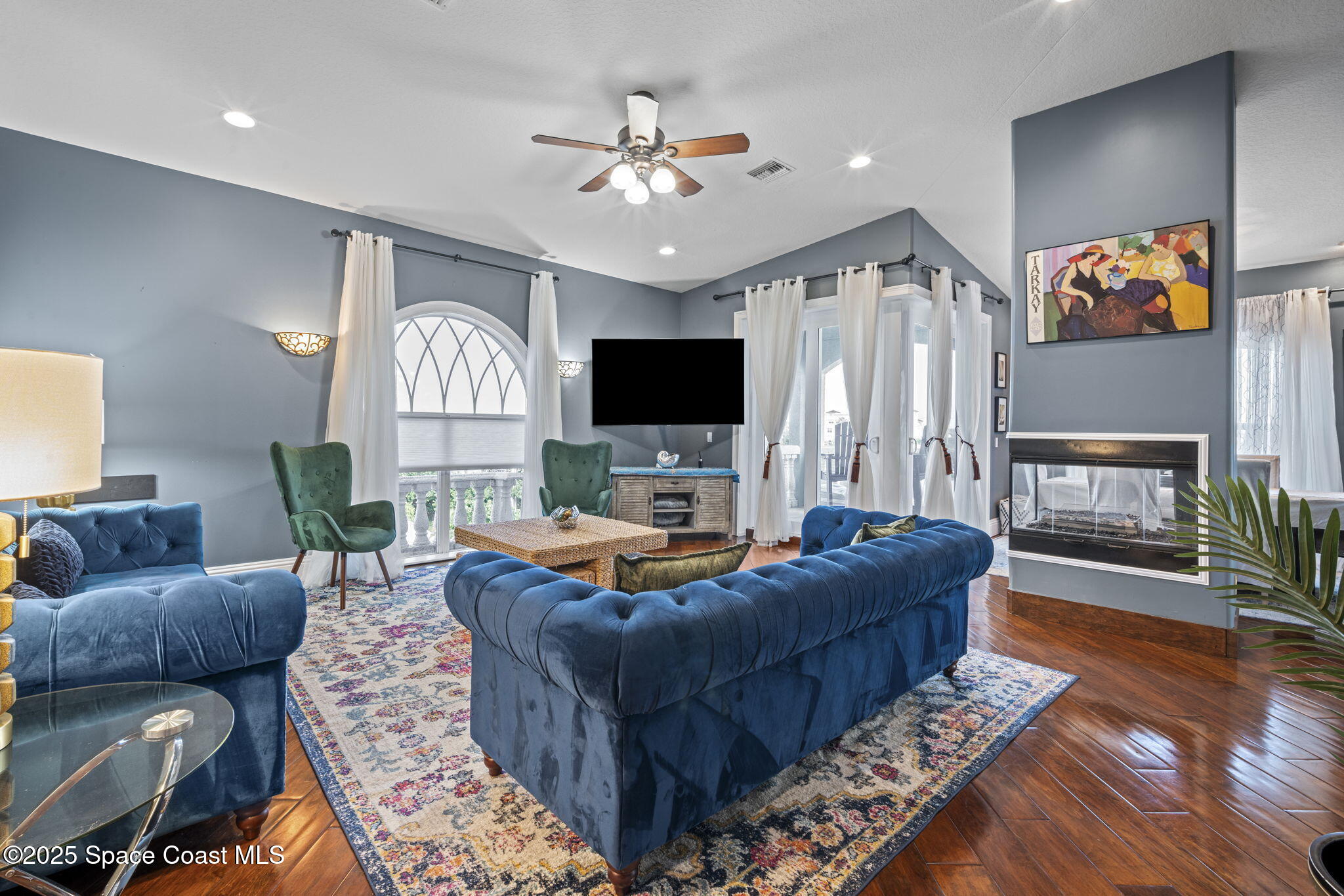 2694 South Atlantic Avenue Cocoa Beach, FL 32931 - Photo 6 of 72 a living room with furniture and a flat screen tv