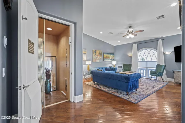 a kitchen with granite countertop a refrigerator a sink dishwasher a dining table and chairs with wooden floor