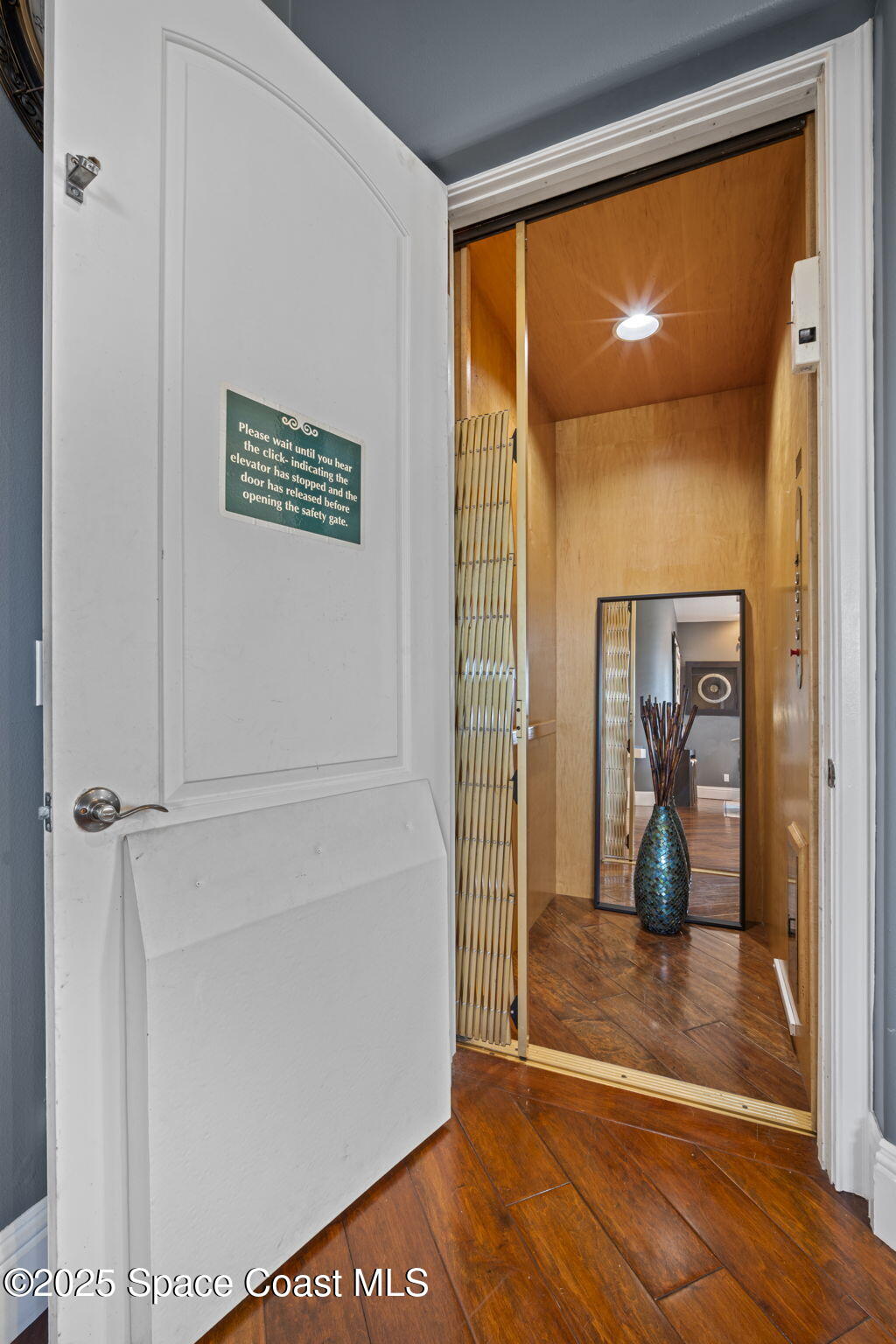 2694 South Atlantic Avenue Cocoa Beach, FL 32931 - Photo 10 of 72 a view of a hallway with wooden floor and a living room