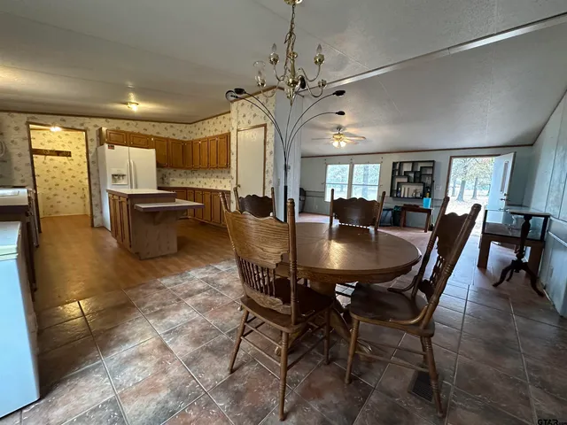 a bathroom with a tub a sink and a mirror