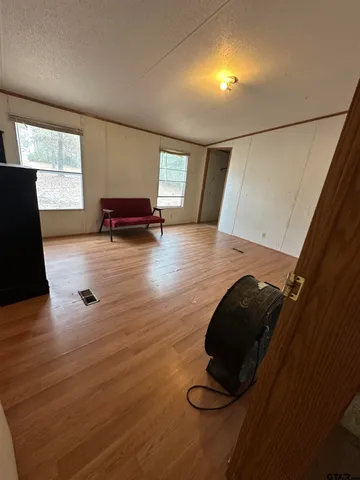 a view of kitchen with refrigerator stove and wooden floor