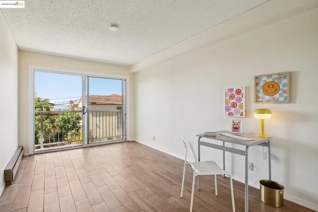 a bedroom with a bed and a balcony view