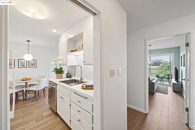 a kitchen with stainless steel appliances kitchen island granite countertop a sink and a refrigerator