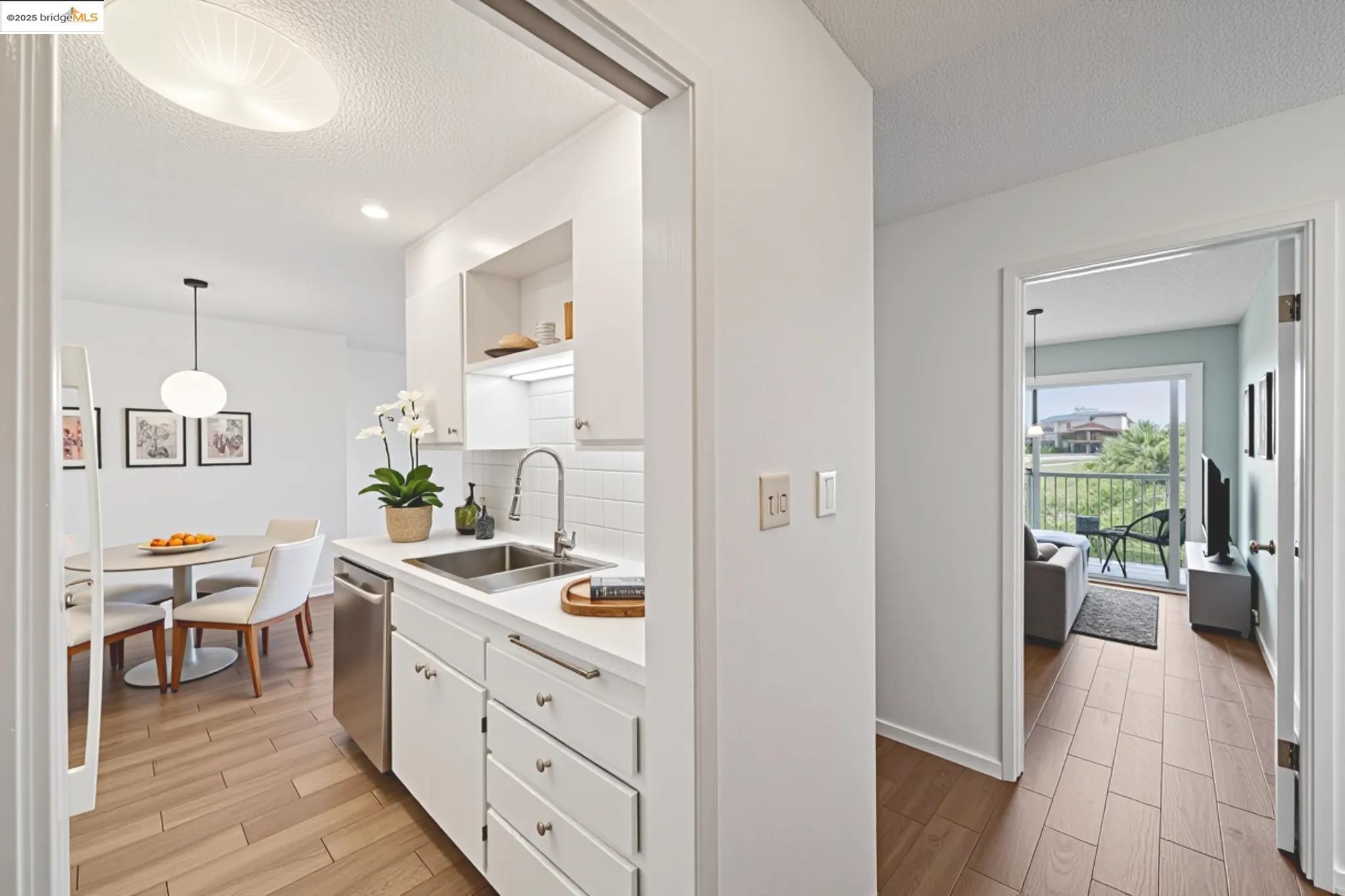 2 Panoramic Way, Unit 105 Berkeley, CA 94704 - Photo 2 of 20 a kitchen with stainless steel appliances kitchen island granite countertop a sink and a refrigerator