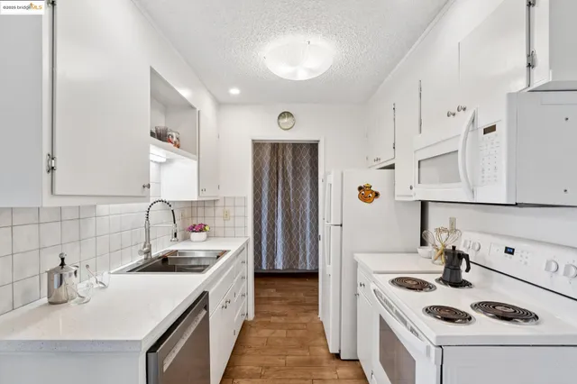 a kitchen with stainless steel appliances granite countertop a sink and cabinets