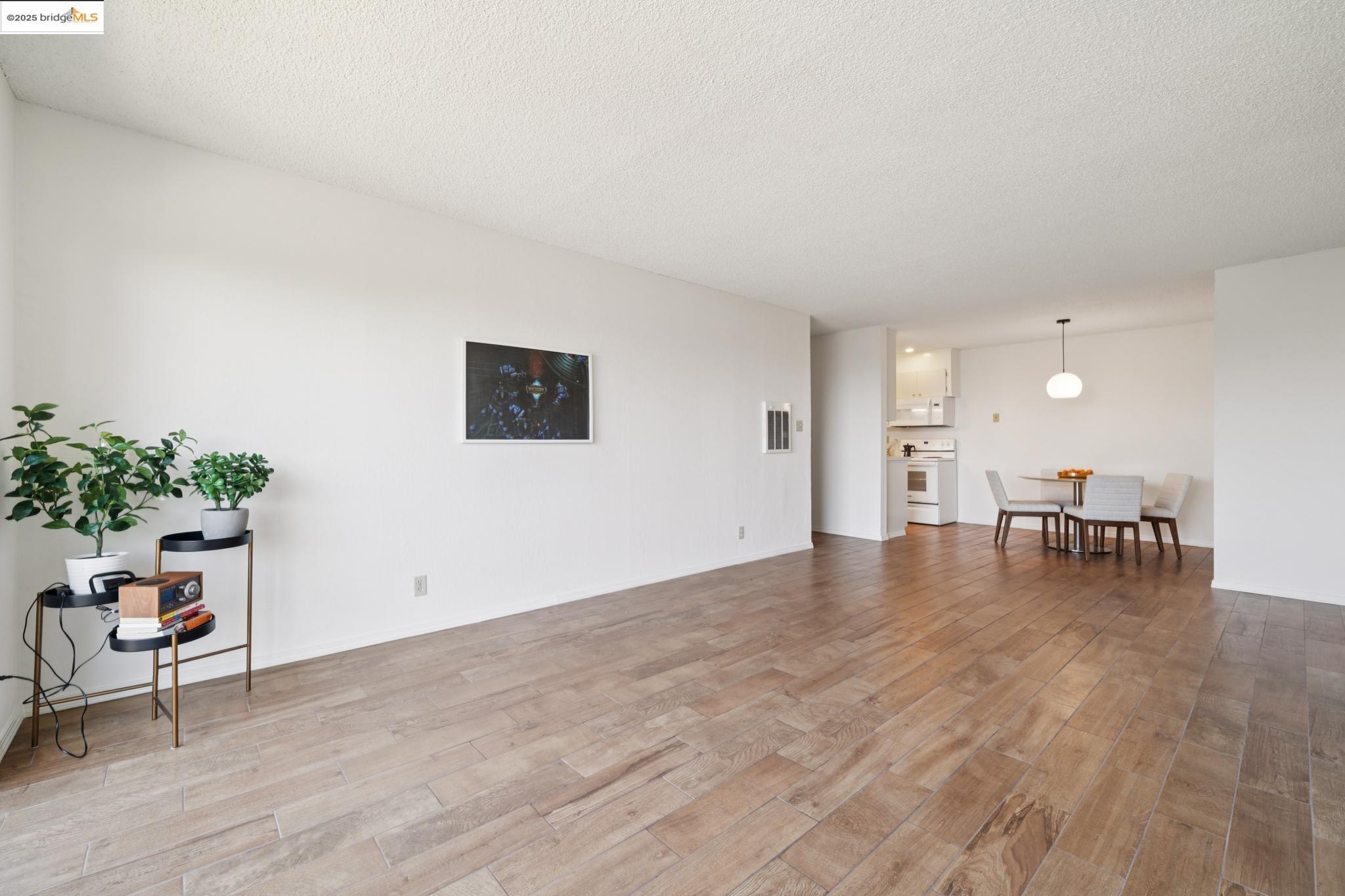 2 Panoramic Way, Unit 105 Berkeley, CA 94704 - Photo 8 of 20 a view of an empty room with kitchen and dining room