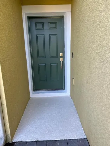 front view of a hallway with a wooden door