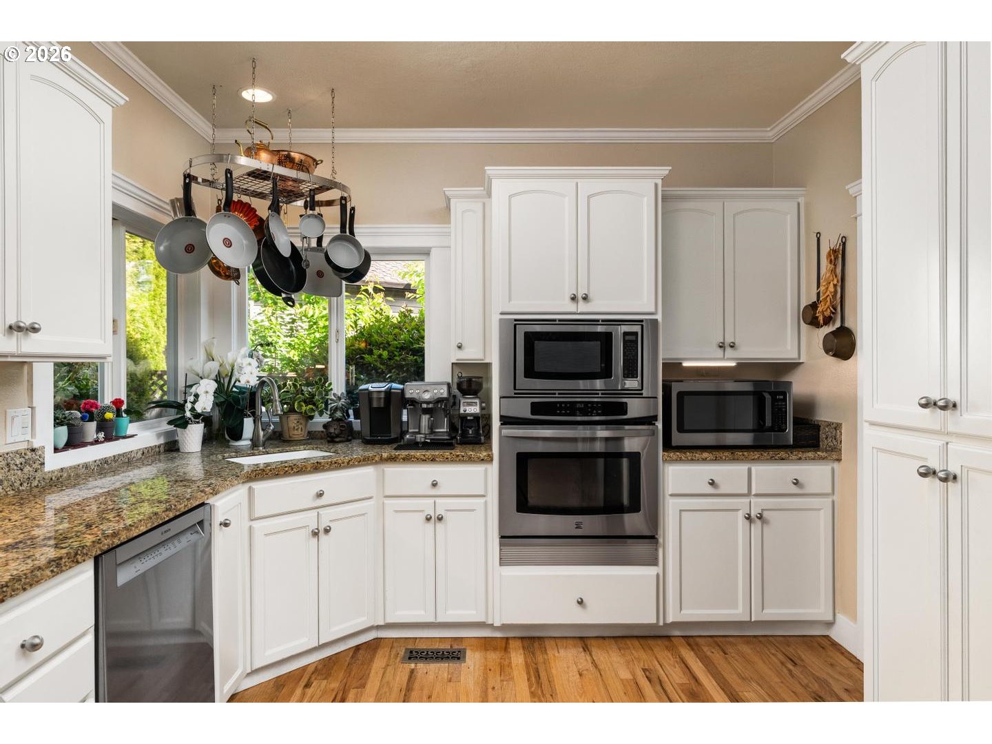 16042 Southwest Waxwing Way Beaverton, OR 97007 - Photo 7 of 48 a kitchen with stainless steel appliances granite countertop a sink and a stove