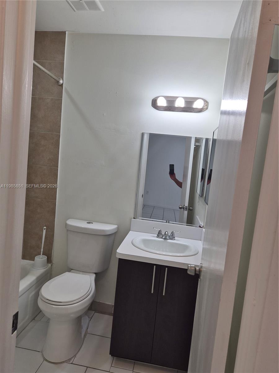 15421 Southwest 81st Cir Lane, Unit 24 Miami, FL 33193 - Photo 4 of 7 a bathroom with a sink toilet and mirror