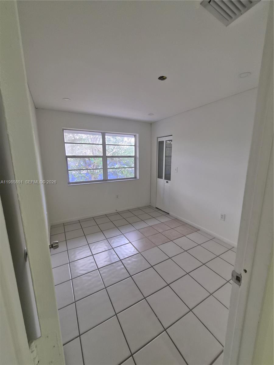 15421 Southwest 81st Cir Lane, Unit 24 Miami, FL 33193 - Photo 6 of 7 a view of an empty room and window